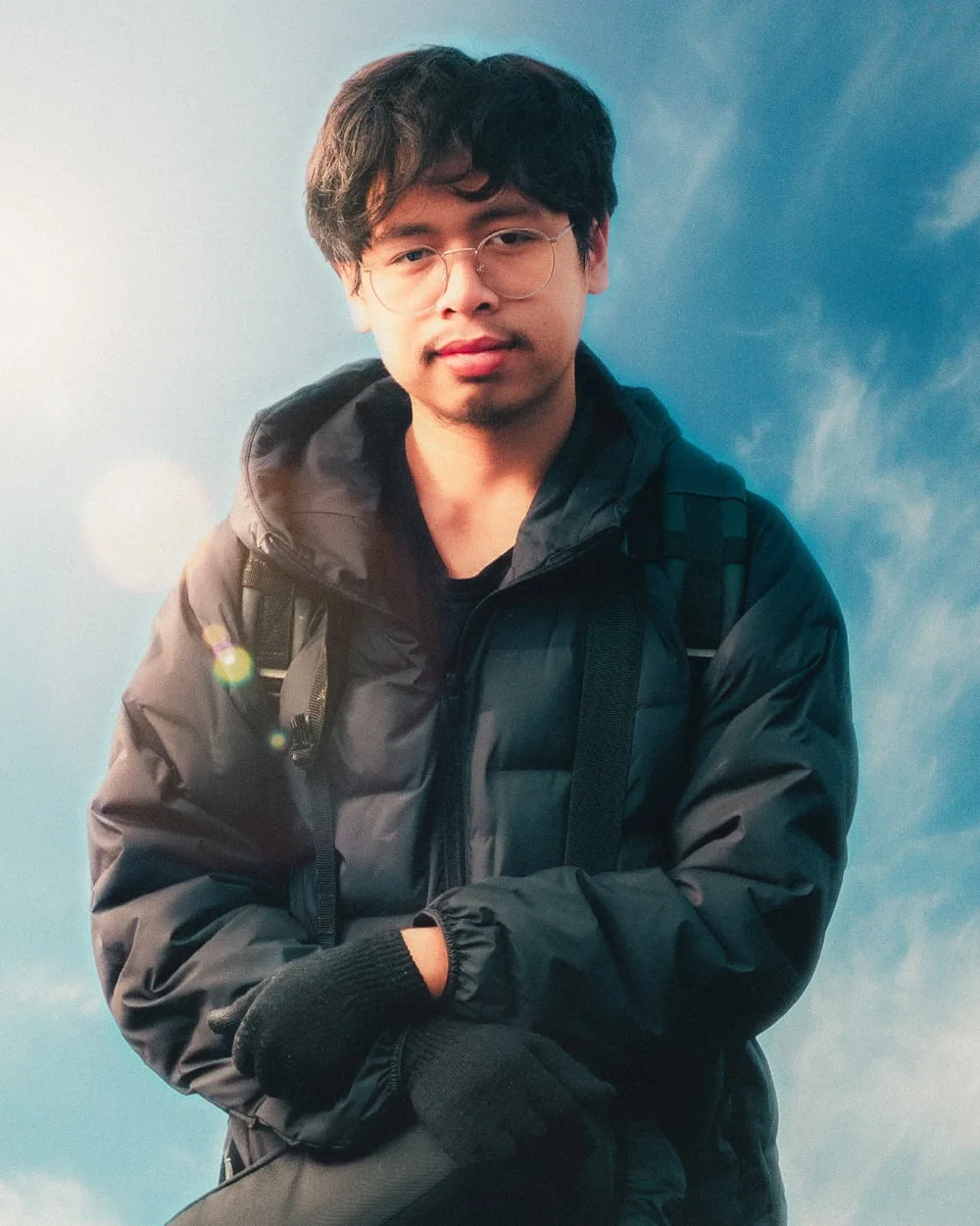 Daffa standing outdoors under a bright blue sky