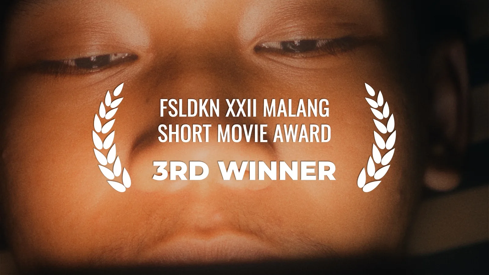Film still with the laurel overlay "FSLDKN XXII Malang Short Movie Award, 3rd Winner"