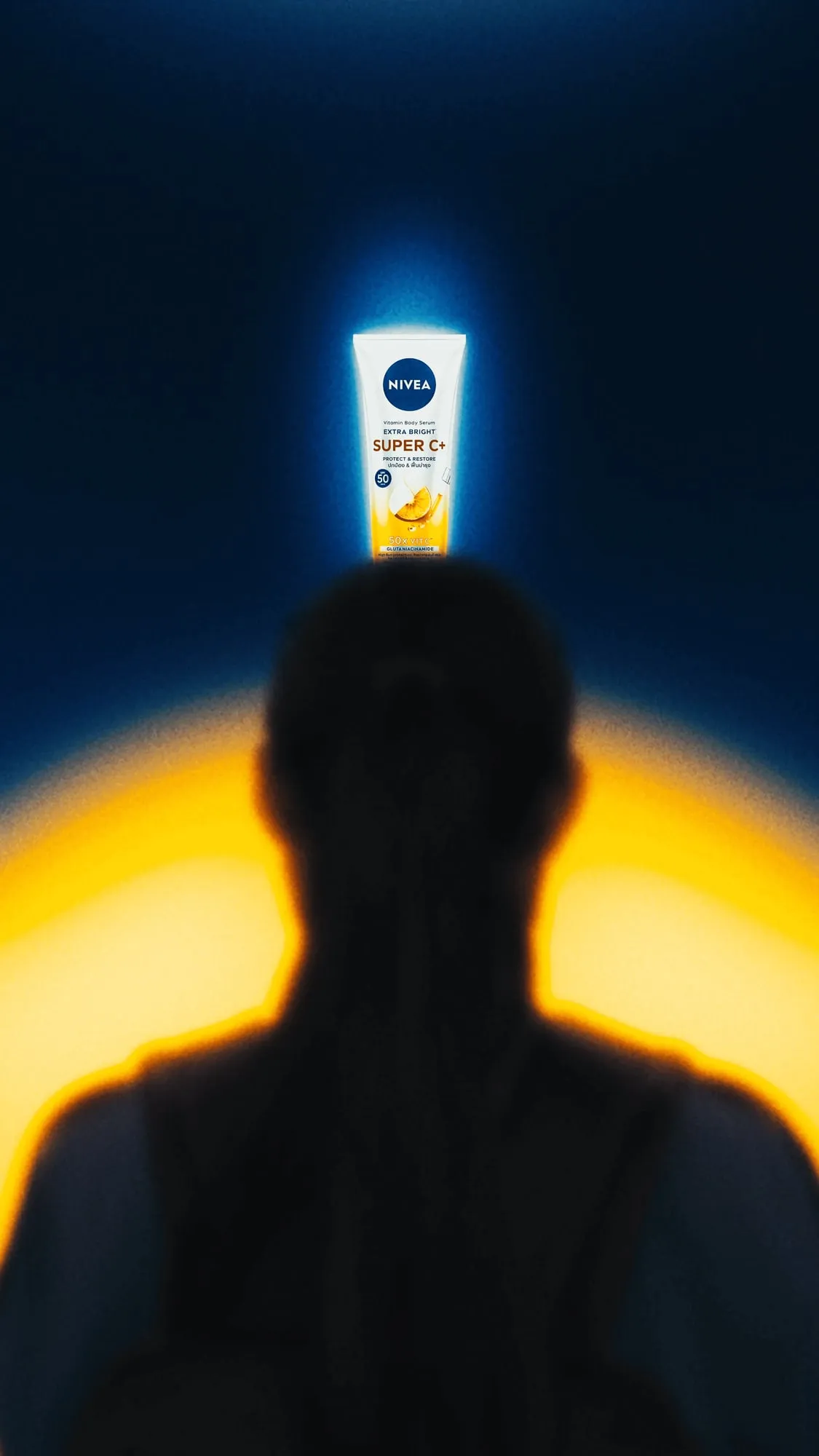 A still from the ad, a NIVEA sunscreen tube glowing above a dark silhouette against a yellow light.